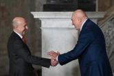 Le ministre italien de la Défense Guido Crosetto (D) et son homologue britannique John Healey se serrent la main durant la cérémonie d'accueil d'un G7 Défense à Naples le 19 octobre 2024