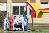 Du personnel médical s'occupe d'un malade du Covid-19 pour le transporter dans un hélicoptère depuis l'hôpital Emile Muller à Mulhouse, le 20 mars 2020