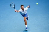 Le Serbe Novak Djokovic contre l'Américain Taylor Fritz en quart de finale de l'Open d'Australie le 23 janvier 2024 à Melbourne
