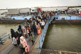 Des réfugiés ukrainiens débarquent d'un ferry pour entrer en Roumanie après avoir traversé le Danuble, le 26 février 2022 à Isaccea-Orlivka