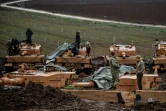 Des soldats turcs sur leurs chars stationnés près de la frontière syrienne à Hassa, dans la province d'Hatay, le 25 janvier 2018, au sixième jour de l'offensive turque lancée contre les forces kurdes du YPG 