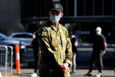 Un membre des forces armées australiennes surveille l'entrée d'un centre de vaccination à Sydney, le 18 août 2021