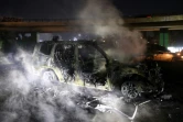 Les restes calcinés d'un véhicule de la Force de l'ONU au Liban (Finul), incendié par des manifestants, sur la route menant à l'aéroport international de Beyrouth, le 14 février 2025