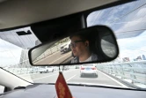 Un chauffeur de taxi dans une rue de Wuhan, le 1er aoûit 2024 dans la province chinoise du Hubei