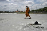 Un moine passe devant l'endroit où des manifestants pro-démocratie avaient fixé une "plaque du Peuple" le 20 septembre 2020 pour défier la monarchie thaïlandaise, qui a depuis été enlevée, le 21 septembre 2020 à Bangkok