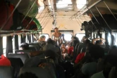 Des migrants à bord d'un bus à destination de Danli, après être arrivés à Trojes, au Honduras, le 11 juin 2022