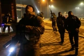 Des policiers ukrainiens près d'un entrepôt touché par une frappe russe à Kiev le 20 mars 2022