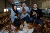 Fabien Sauleman (C), co-fondateur de Poulehouse, son associée Elodie Pellegrin  (G) et Sebastien Neusch, responsable du numérique et du marketing posent parmi les poules de la ferme de Coussac-Bonneval (40 km au sud de Limoges), le 6 avril 2018