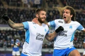 La joie du défenseur croate de Marseille, Duje Caleta-Car, félicité par le défenseur Mattéo Guendouzi, après avoir marqué le 2e but face à Strasbourg, lors de la 18e journée de Ligue 1, le 12 décembre 2021 au Stade de La Meinau