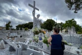 Leticia Mojarrieta se recueille devant la tombe d'Amelia Goyri, surnommée "La Miraculeuse", pour lui demander une faveur, au cimetière Colon de La Havane, le 12 février 2024 à Cuba