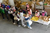 Des bénévoles des Restos du coeur distribuent des produits alimentaires à des étudiants le 26 mars 2021 au Vélodrome de Marseille