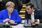 La chancelière allemande Angela Merkel (g) et le Premier ministre grec Alexis Tsipras (R) lors d'une réunion de l'Otan, le 11 juillet 2018 à Bruxelles 