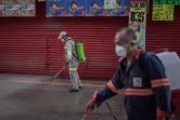 Des employés désinfectent un marché alimentaire pour lutter contre l'épidémie de coronavirus, le 24 mars 2020 à Mexico
