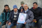 Othman Yahyaoui, entouré de sa famille, présente le 21 jnvier 2016 à Kasserine un portrait de son fils, Ridha Yahyaoui, mort lors d'une manifestation 