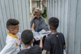 Trois jeunes garçons proposent des oeuvres de leur création en porte-à-porte à l'occasion du nouvel an éthiopien, Enkutatash, à Addis-Abeba, le 11 septembre 2022 