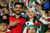Un couple d'Iraniens assistent, sur écran géant au stade Azadi à Téhéran, au match contre le Portugal au Mondial, le 25 juin 2018