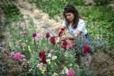 La Franco-japonaise Masami Lavault cultive des fleurs dans un champ près du  cimetière de Belleville, le 1er juillet 2020 à Paris