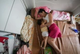 Cette photo prise le 5 août 2020 montre Chao Anya allaitant son bébé dans leur domicile à Shanghai