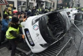 Destruction d'une voiture pendant la manifestation des "gilets jaunes" près des Champs-Elysées le 1er décembre 2018