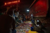 Des touristes achètent le 5 juillet 2017 des produits importés de Corée du Nord dans une rue proche du Pont de l'Amitié dans la ville frontalière chinoise de Dandong