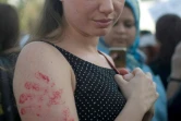Photo d'une jeune femme arborant sur son bras des empreintes de main peintes en rouge, lors d'une manifestation contre le harcèlement sexuel le 14 juin 2014 au Caire