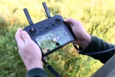 Cédric Petit, fondateur de l'association "Sauvons Bambi", utilise un drone pour repérer les faons près de Namur, dans le centre de la Belgique, le 24 juin 2024