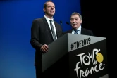Le directeur du Tour de France Christian Prudhomme et le Belge Eddy Merckx, quintuple vainqueur de la Grande Boucle, lors de la présentation de l'édition 2019, le 25 octobre 2018 à Paris  