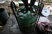 Un homme travaille dans un laboratoire de pâte de coca dans le canyon de Micay, bastion de l'État-major central (EMC), dans le département du Cauca, le 25 mars 2024 en Colombie