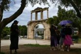 Des touristes s'abritent à l'ombre, à Athènes, le 13 juin 2024