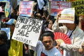 Manifestation contre les récentes actions de la Chine dans les eaux disputées de la mer de Chine méridionale, devant le consulat chinois à Makati, en banlieue de Manille, le 9 avril 2024 aux Philippines