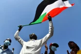 Un manifestant soudanais anti-coup d'Etat brandit le drapeau national lors d'un rassemblement dans la ville d'Omdurman, jumelle de Khartoum, le 30 octobre 2021