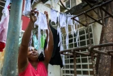 Marina Ibañez, employée de crèche, fait sécher ses masques au soleil, dans le quartier du Vedado, le 30 mars 2020 à La Havane, pendant l'épidémie de coronavirus à Cuba