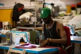 Un migrant africain travaille dans l'atelier de la marque Top Manta créée par le syndicat des vendeurs à la sauvette, le 11 juin 2021 à Barcelone