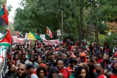 Des milliers de personnes issues de la diaspora ultramarine, vêtues de rouge, manifestent le 3 novembre 2024 à Paris contre la vie chère en Outre-mer