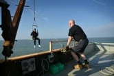 Le prince Liam Bates (G) est hissé par un treuil sur la plateforme qui constitue laprincipauté de Sealand, le 16 septembre 2021 