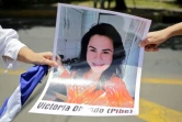 Des manifestants tiennent, lors d'une manifestation à Managua, le 30 août 2018, la photo d'une jeune femme détenue pour avoir manifesté contre le président Ortega
