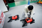 Un ingénieur contrôle un robochien baptisé AlphaDog dans l'atelier de l'entreprise Weilan à Nankin, le 2 avril 2021