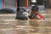 Floodwater raced through parts of Manila after huge downpours