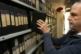 Un employé du département des archives de la chaîne de télévision libanaise "Télé-Liban" sort une cassette d'une étagère, à Beyrouth, le 29 décembre 2023
