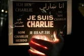 Un homme porte une bougie et une pancarte avec les mots "Je suis Charlie", le 8 janvier 2015 à Strasbourg