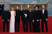 Le cinéaste russe Kirill Serebrennikov (c) entourés par les acteurs et membres de son équipe sur le tapis rouge du Festival de Cannes pour la projection de son film "La femme de Tchaïkovski", le 18 mai 2022 à Cannes