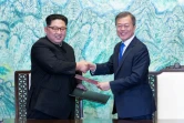 L président sud-coréen Moon Jae-in (d) et le leader nord-coréen Kim Jong Un échangent des documents signés pendant le sommet intercoréen, le 27 avril 2018 à Panmunjom