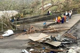 Des habitants au milieu de débris de tôles et de bois après le passage du cyclone Chido à Mayotte, le 15 décembre 2024