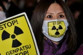 Une manifestante proteste contre Tepco, l'opérateur de la centrale, quelques jours après l'accident survenu à la centrale nucléaire de Fukushima, Tokyo le 30 mars 2011.