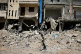 Un jeune Palestinien marche parmi des ruines à Khan Younès, grande ville du sud de Gaza, après le retrait des troupes israéliennes, le 7 avril 2024  