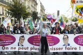 Des manifestants, descendus dans la rue à l'appel de la CGT, de la FSU et de Solidaires, pour réclamer des hausses de salaires et défendre l'emploi, tiennent une banderole, le 8 octobre à Paris