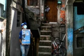 Un employé de Favela Brasil Xpress livre un colis à livrer dans la favela Paraisopolis, le 1er décembre 2021 à Sao Paulo