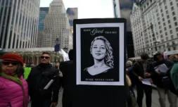 Une personne brandit un portrait de Renee Nicole Good, tuée par un policier de l'immigration à Minneapolis, lors d'une manifestation à New York, le 11 janvier 2025 ( AFP / TIMOTHY A. CLARY )