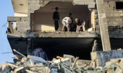 Des Palestiniens fouillent les décombres d'un immeuble détruit par un bombardement israélien à Rafah, le 19 octobre 2023 dans le sud de la bande de Gaza ( AFP / MOHAMMED ABED )