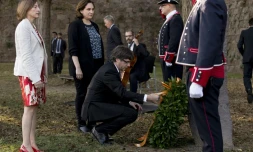 Le président de la région catalane Carles Puigdemont (C), la présidente du Parlement régional Carme Forcadell (G) et la maire de Barcelone Ada Colau (2e G), se receuillent sur la tombe du leader catalan Lluis Companys, à Barcelone, le 15 octobre 2017